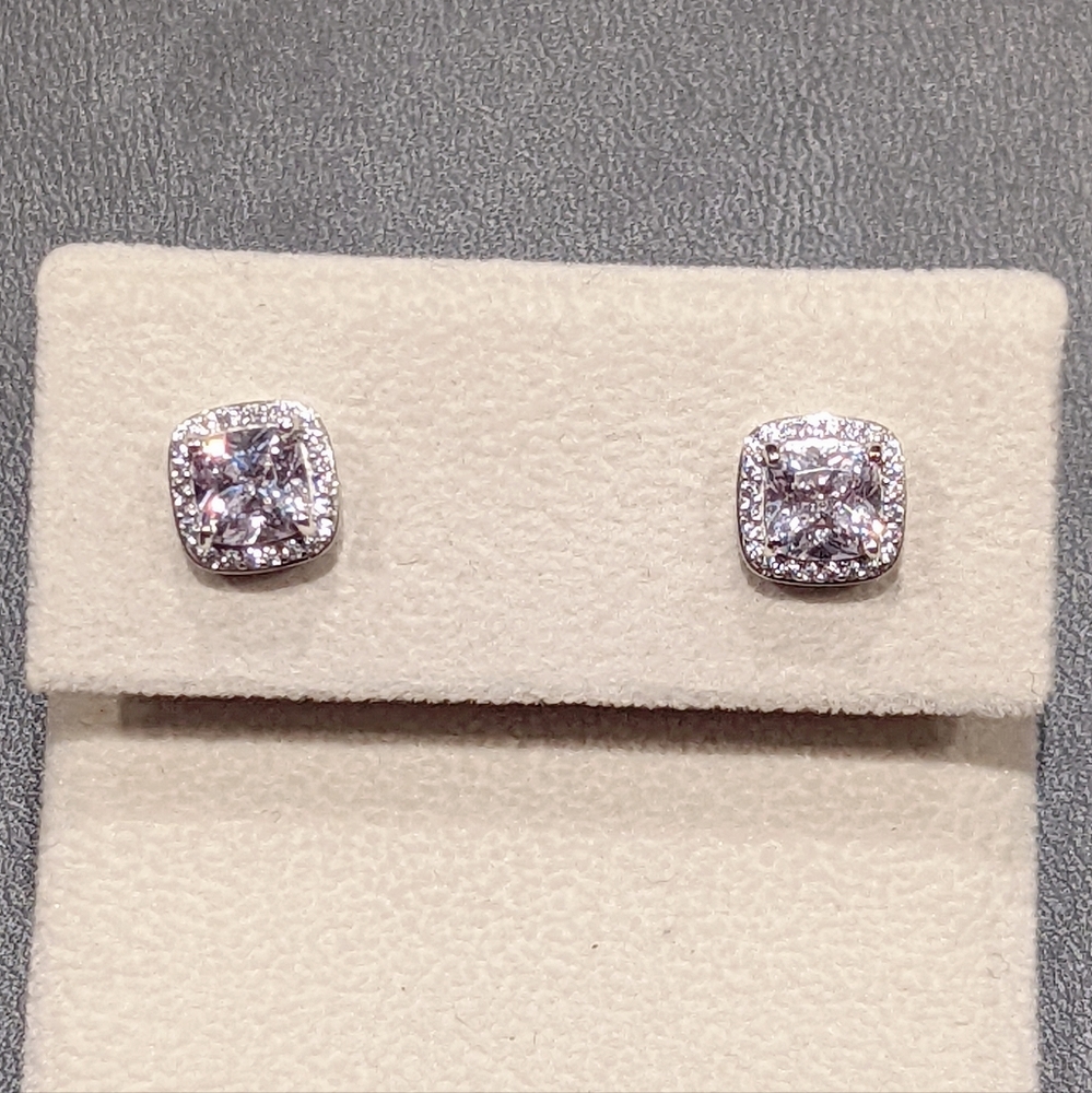 Cushion cut cubic zirconia with pave halo stud earrings. Rhodium plated silver.